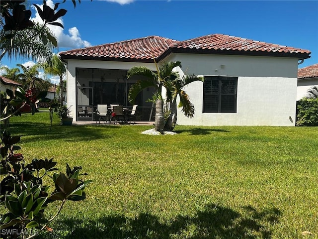 rear view of property featuring a yard