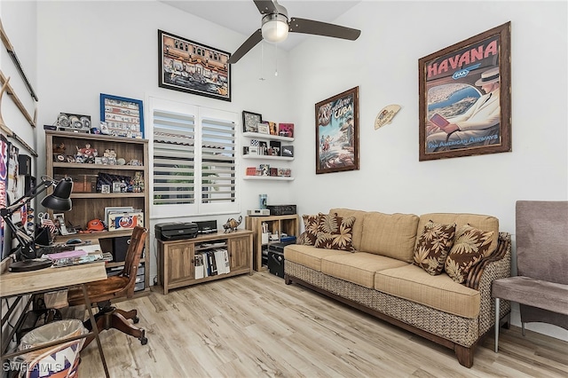 office area featuring a towering ceiling, light hardwood / wood-style floors, and ceiling fan