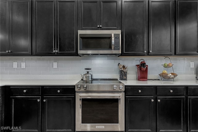 kitchen with stainless steel appliances and tasteful backsplash