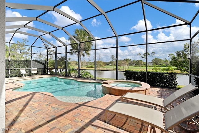 view of swimming pool featuring a patio, a water view, glass enclosure, and an in ground hot tub