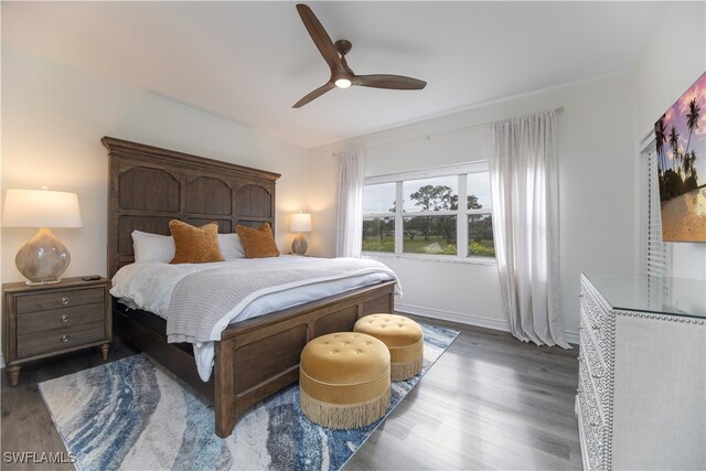 bedroom featuring ceiling fan and dark hardwood / wood-style floors