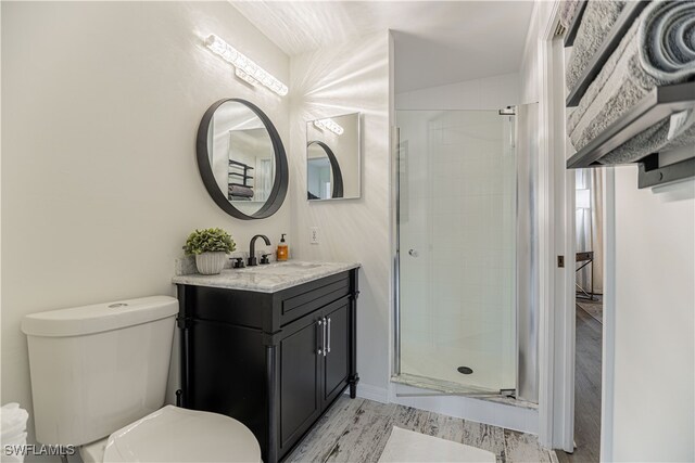 bathroom featuring hardwood / wood-style floors, a shower with door, vanity, and toilet