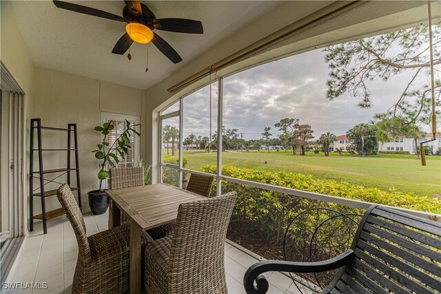 sunroom featuring ceiling fan