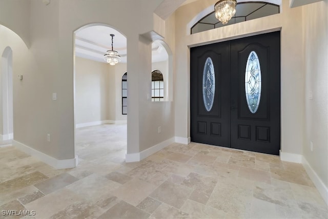 entryway with a chandelier