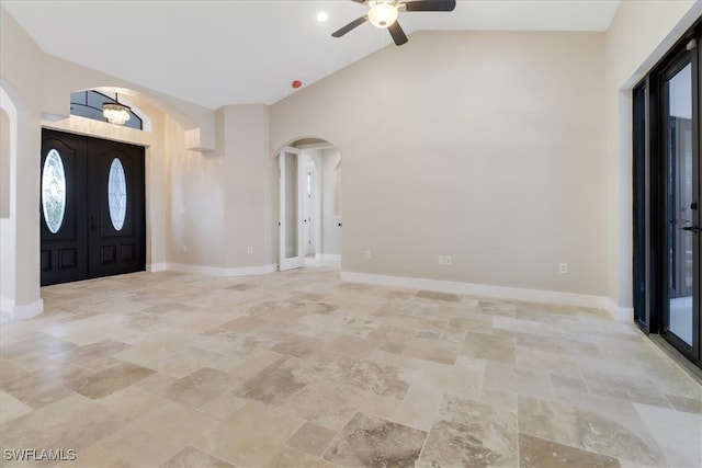 entryway with ceiling fan, plenty of natural light, and vaulted ceiling