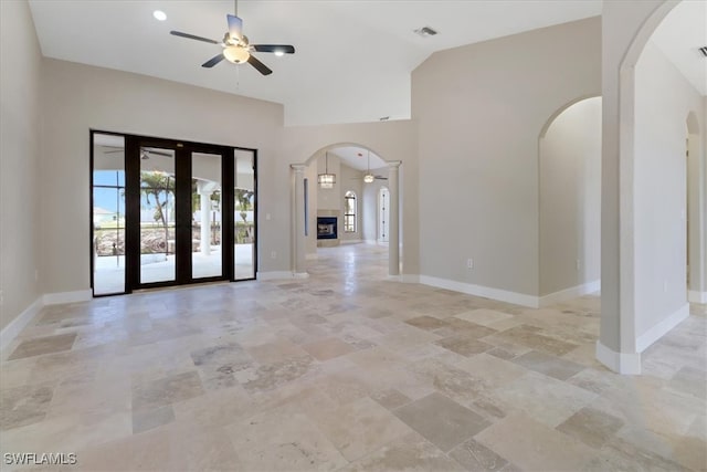 spare room featuring ceiling fan, french doors, and high vaulted ceiling