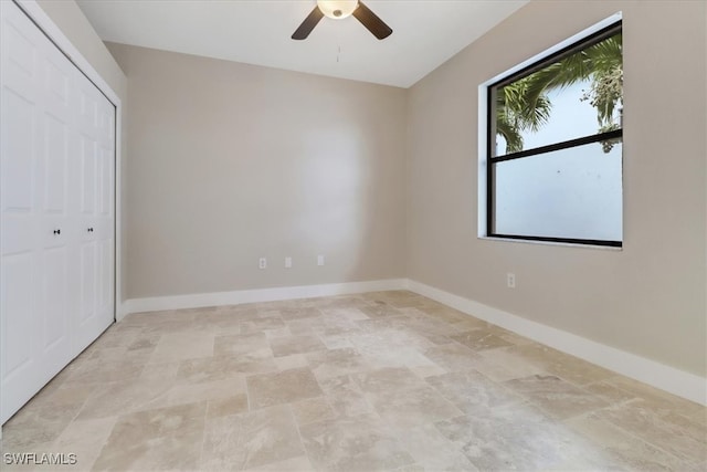 unfurnished bedroom featuring ceiling fan and a closet