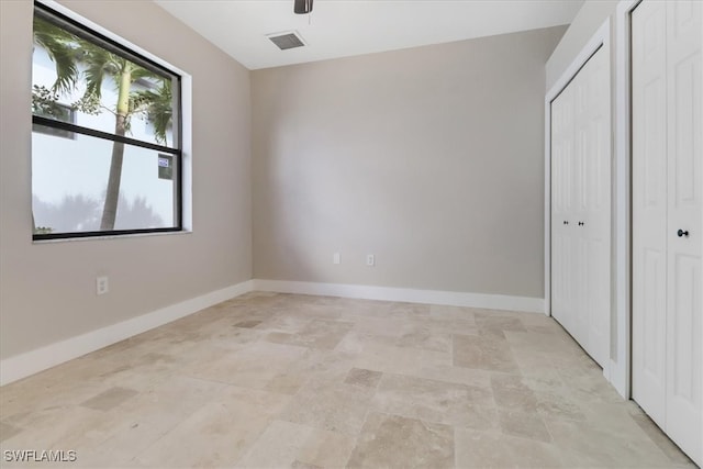 unfurnished bedroom featuring ceiling fan