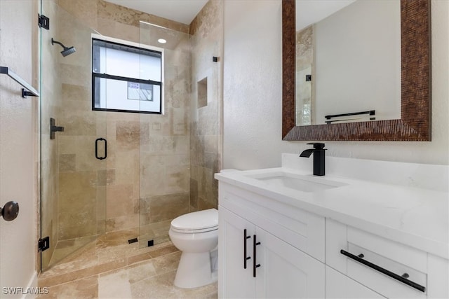 bathroom featuring vanity, an enclosed shower, and toilet