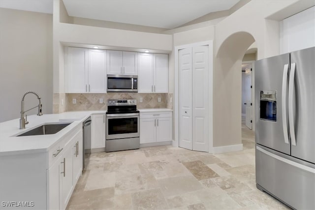 kitchen featuring white cabinetry, decorative backsplash, sink, and appliances with stainless steel finishes