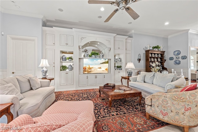 living room with ceiling fan and crown molding