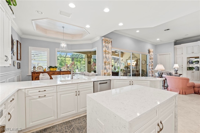 kitchen with white cabinets, stainless steel dishwasher, sink, and crown molding