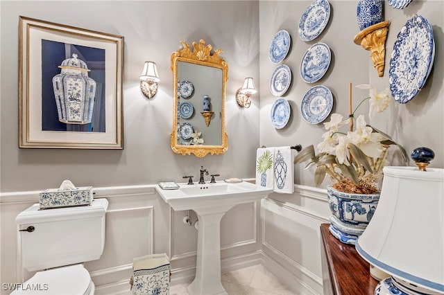 bathroom with toilet and tile patterned floors