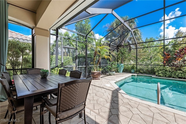 view of swimming pool featuring a lanai and a patio area