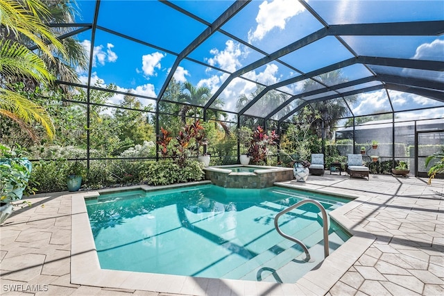 view of swimming pool with a lanai, an in ground hot tub, and a patio area