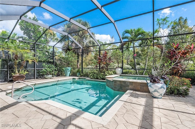 view of swimming pool with a lanai, an in ground hot tub, and a patio area