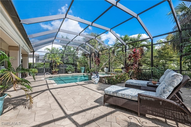 view of patio / terrace with a lanai and a swimming pool with hot tub