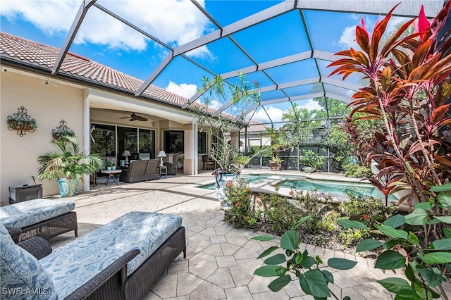 view of patio / terrace with ceiling fan, glass enclosure, and an outdoor hangout area