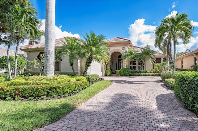 mediterranean / spanish-style home featuring a garage