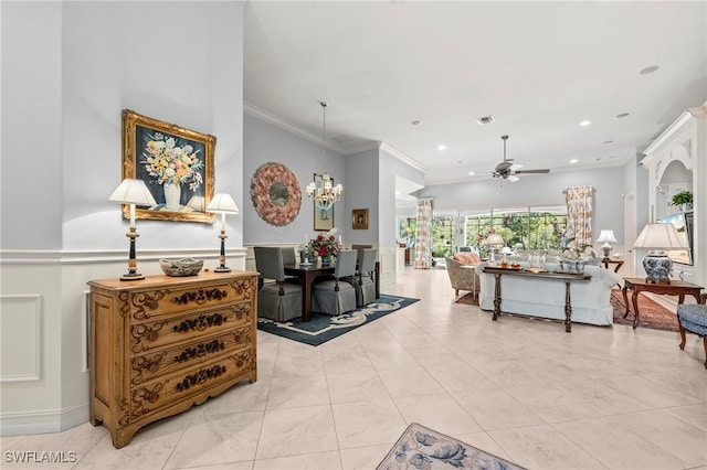 living room featuring ceiling fan with notable chandelier, light tile patterned floors, and crown molding