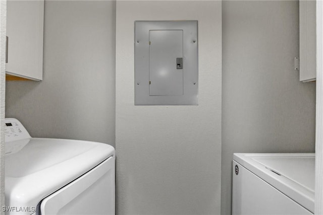 clothes washing area featuring electric panel and independent washer and dryer