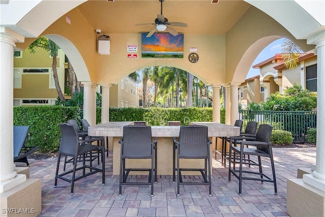 view of patio / terrace with a bar and ceiling fan