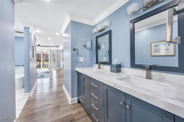 bathroom featuring crown molding, toilet, vanity, and hardwood / wood-style flooring