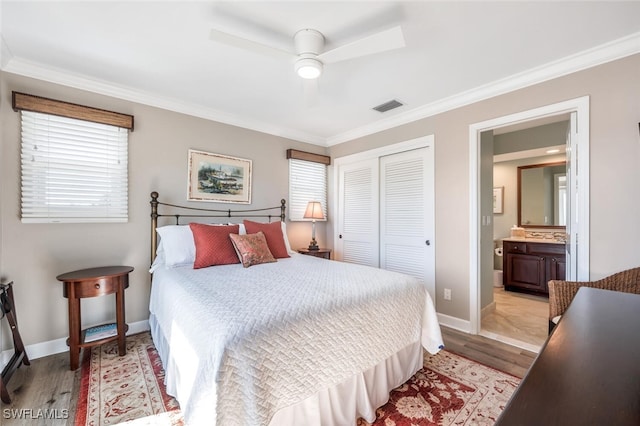 bedroom with ceiling fan, a closet, ornamental molding, and light hardwood / wood-style flooring