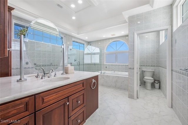 full bathroom with vanity, shower with separate bathtub, toilet, and tile walls