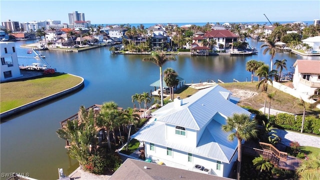 drone / aerial view with a water view and a residential view