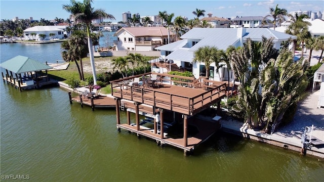 view of dock with a water view, boat lift, and a residential view