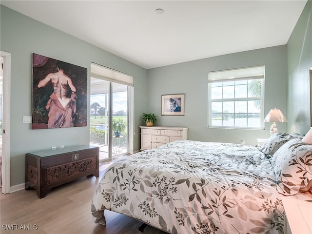 bedroom featuring access to exterior and light hardwood / wood-style flooring