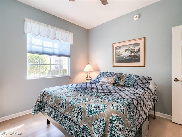 bedroom with ceiling fan and light wood-type flooring