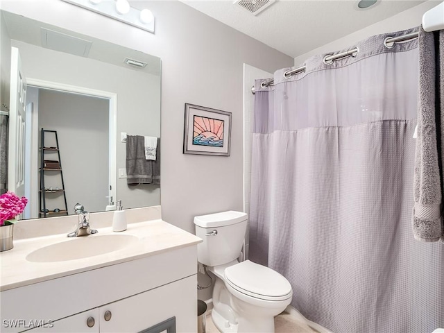 bathroom featuring vanity, a shower with shower curtain, and toilet