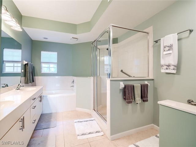 bathroom featuring tile patterned floors, vanity, and plus walk in shower