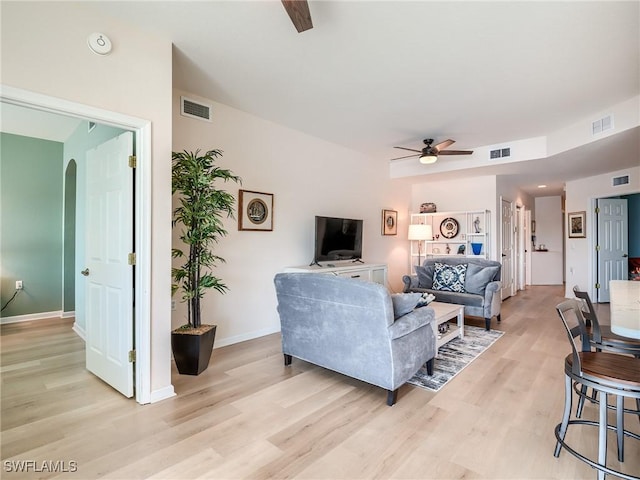 living room with ceiling fan and light wood-type flooring