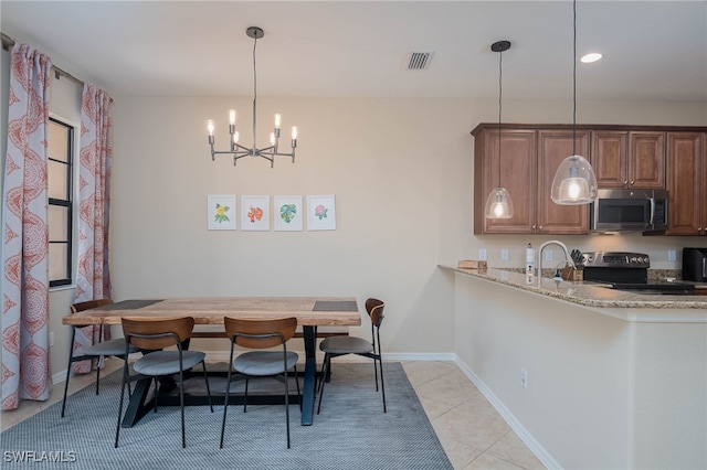 dining space featuring a chandelier and light tile patterned flooring