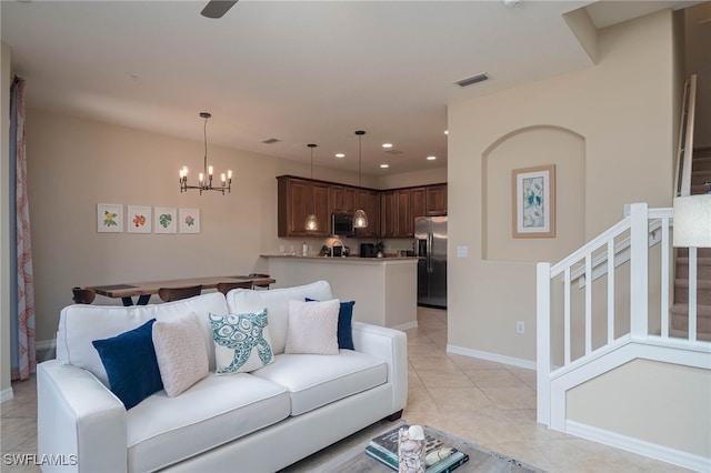 tiled living room featuring a notable chandelier