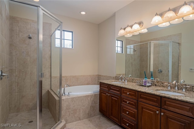 bathroom with independent shower and bath, vanity, and tile patterned flooring