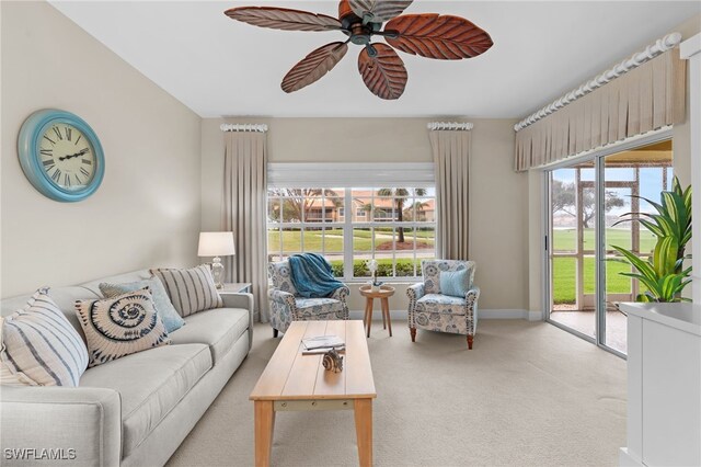 carpeted living room featuring ceiling fan