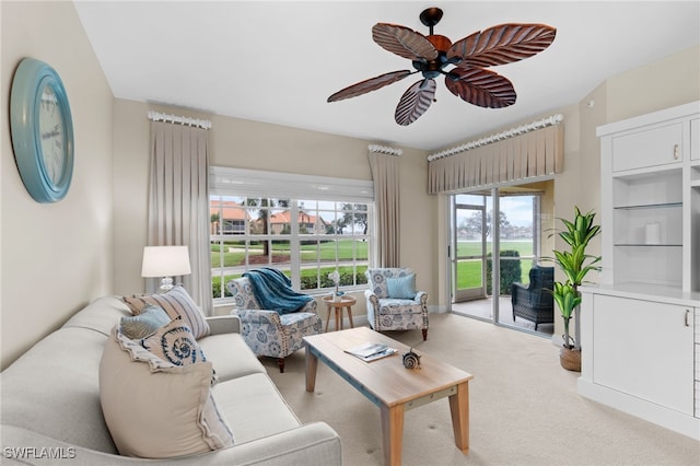 living room with ceiling fan and light carpet