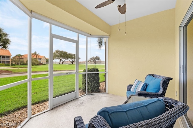 sunroom featuring ceiling fan