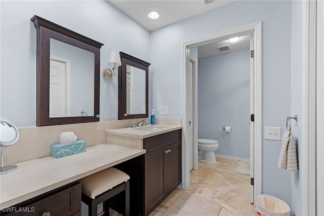 bathroom featuring vanity and toilet