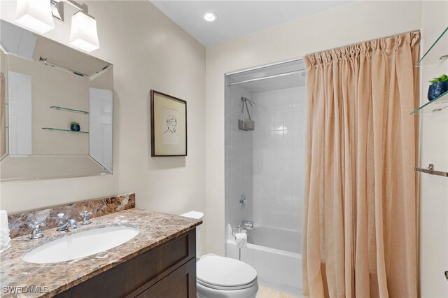 full bathroom featuring shower / bathtub combination with curtain, vanity, and toilet