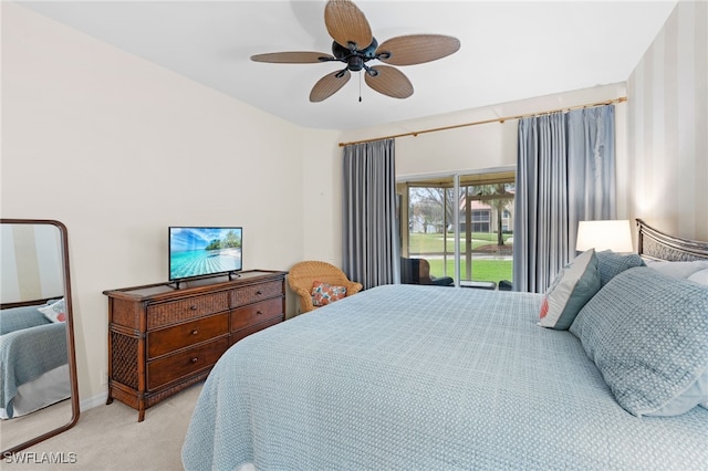 bedroom featuring access to outside, light colored carpet, and ceiling fan