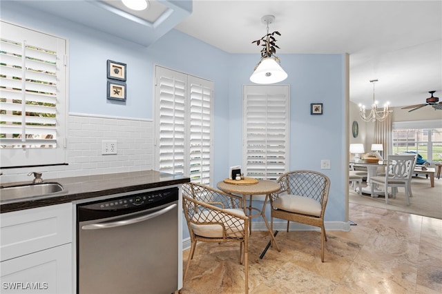 kitchen featuring sink, white cabinets, hanging light fixtures, stainless steel dishwasher, and ceiling fan