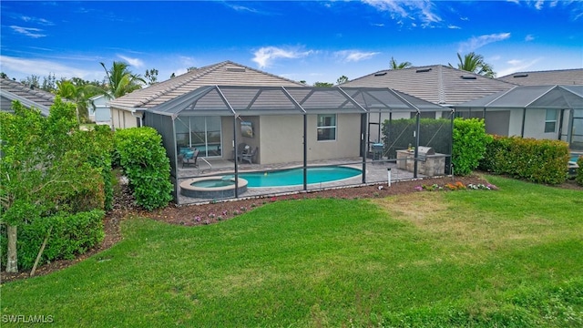 back of property featuring glass enclosure, a lawn, a patio area, and a tile roof