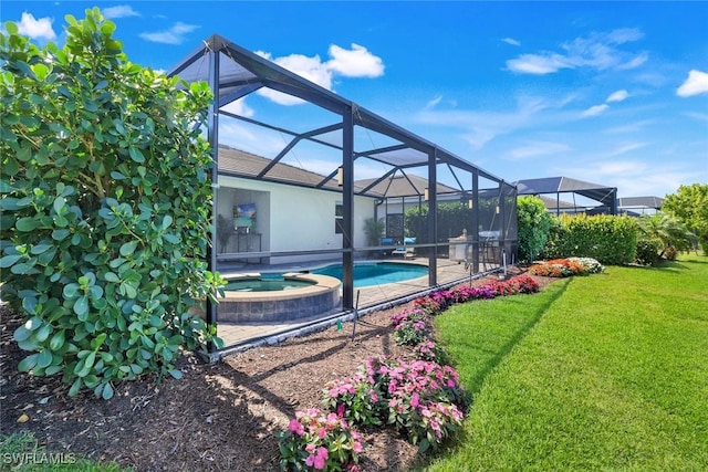 view of pool featuring a lanai, a pool with connected hot tub, and a yard