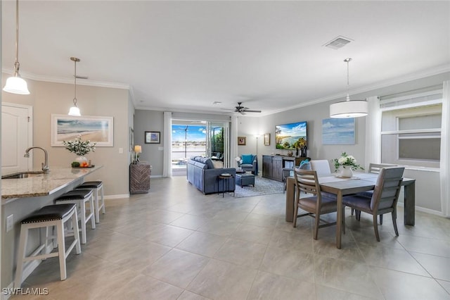 dining area with visible vents, crown molding, baseboards, and light tile patterned floors