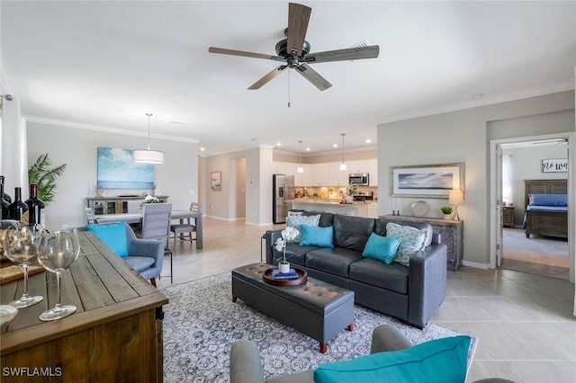 living area with light tile patterned floors, ceiling fan, and crown molding